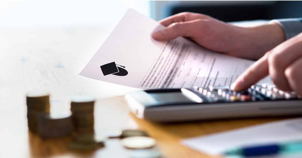 Person working on finances with a calculator