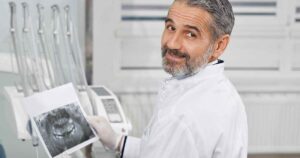 Older dental professional considering retirement after life as a dentist. 