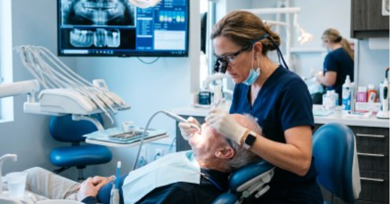 A dentist actively treating a patient